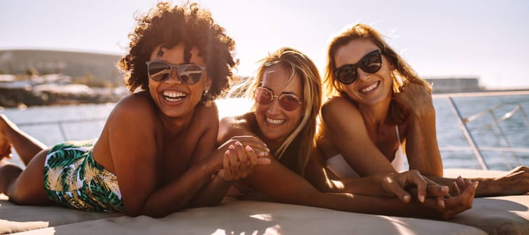 Young happy people on a yacht.