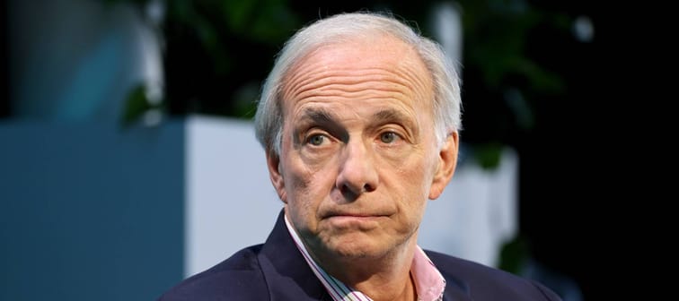 Billionaire Ray Dalio looks at the camera with a worried expression and pursed lips.
