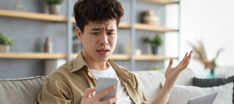 Man looking shocked at his phone