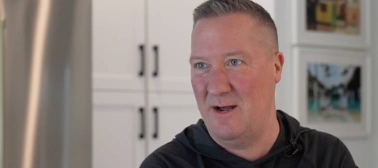 Man in kitchen speaking on camera.