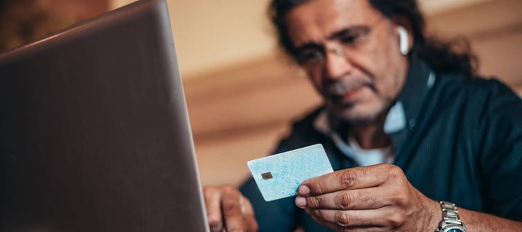 Man making payment online with credit card.