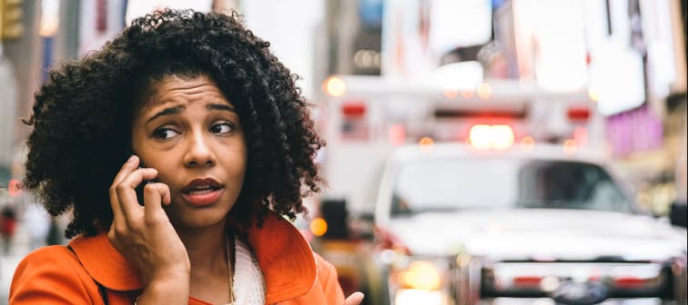 Concerned woman on the phone in New York City.
