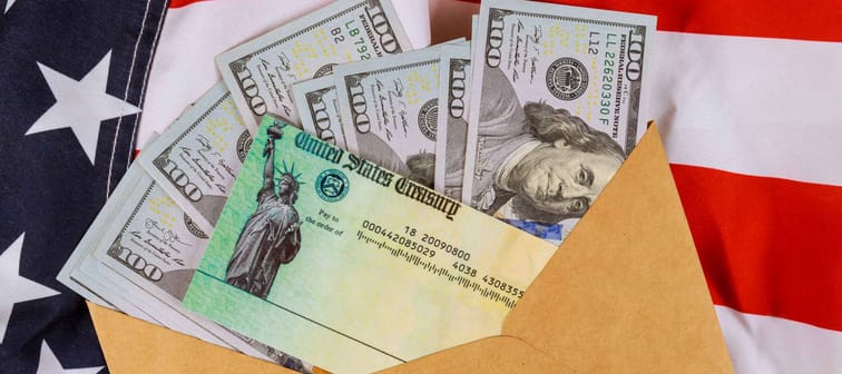 Senate stimulus deal includes individual checks virus economic stimulus plan USA dollar cash banknote on American flag Global pandemic Covid 19 lockdown
