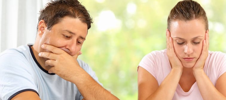 Man and woman worried about their financial state