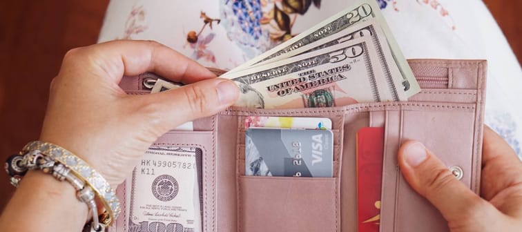 Woman taking money out of wallet