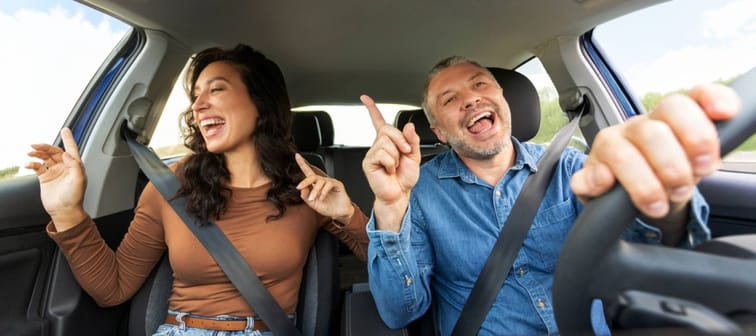 Happy couple driving.