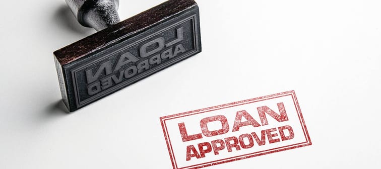 Rubber stamping that says 'Loan Approved'.