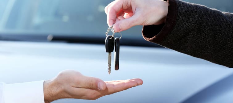 man buying a car keys being handed over