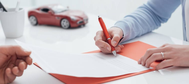 Woman signing car loan