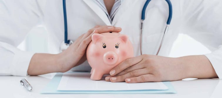 Female doctor and piggy bank: health insurance, medical expenses and tax concept