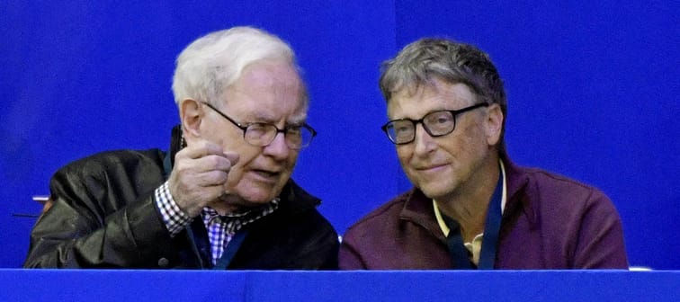 Warren Buffett sits with Bill Gates
