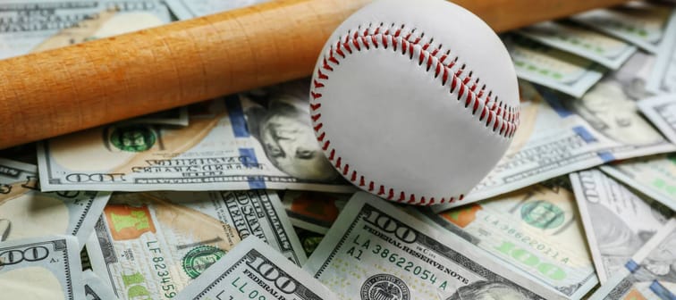 Baseball and bat on dollars background. Corruption concept