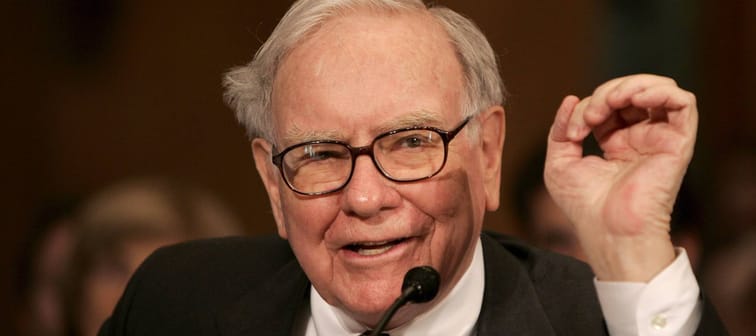 Warren Buffett talks into microphone