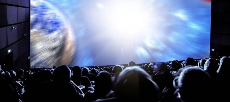 Cinema. The audience in 3D glasses watching a movie. Elements of this image furnished by NASA.