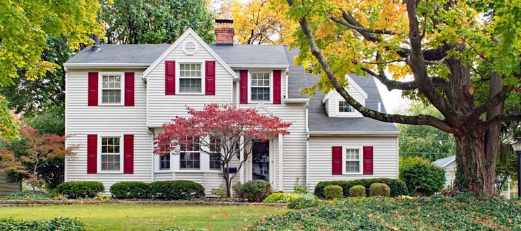 House in Fall with Red Shutters