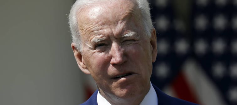 Joe Biden makes a face while speaking in front of the White House