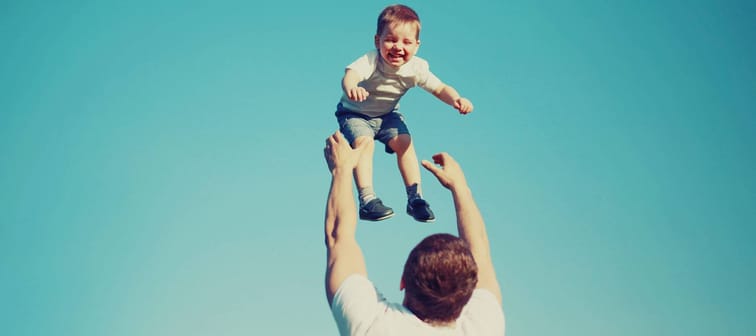 Vintage colors photo happy father and child having fun outdoors, carefree, blue sky, family, travel, vacation, childhood, father's day - concept
