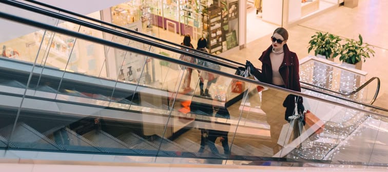 Woman on an escalator in a shopping mall