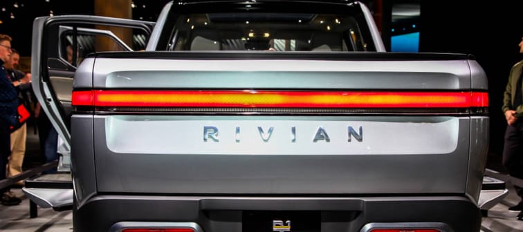 The Rivian logo on the tailgate of a pickup truck electric vehicle