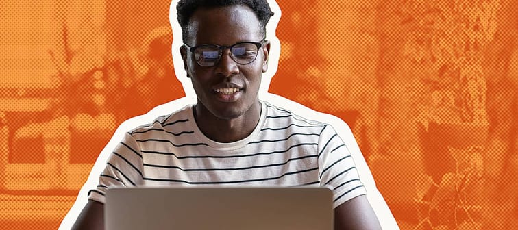 Black man watching educational webinar on laptop, studying, preparing for exam, talk in video chat.