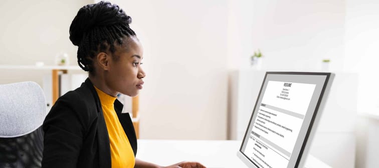 African Business Manager Reading Resume Or CV Before Interview