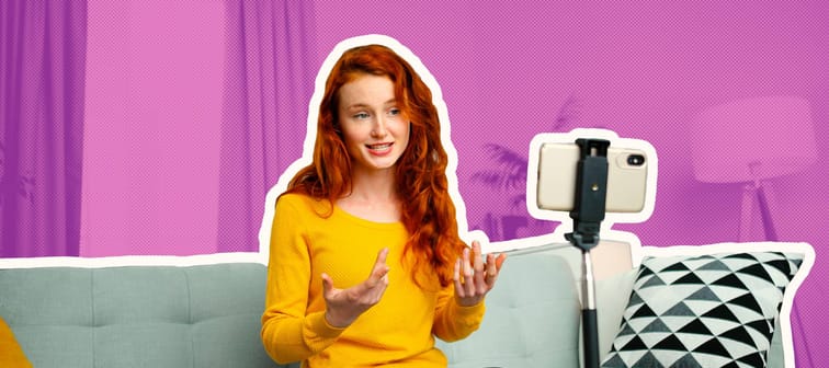 Portrait of beautiful cheerful redhead girl with headsets have video call.
