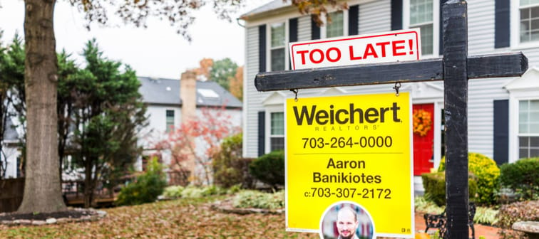 A real estate sign in front of house in Fairfax County, Virginia, that reads "too late."