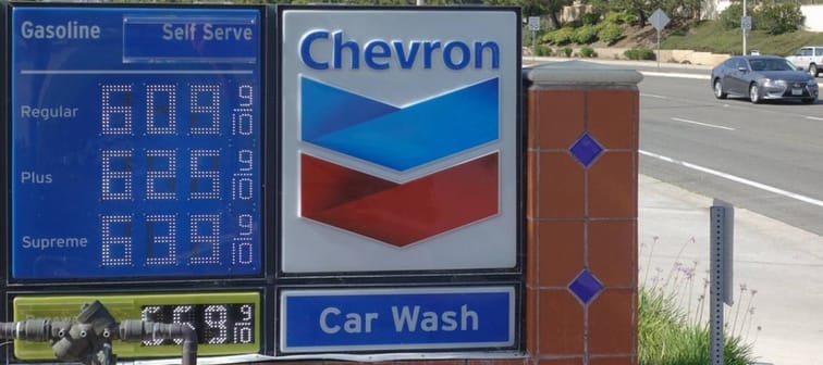 A sign on a Chevron gas station with high fuel prices around $6 per gallon in Vista, California