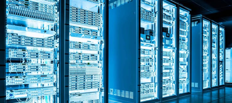 Big data dark server room with bright blue equipment