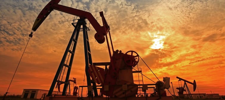 An oil pump rig pictured at sunset.