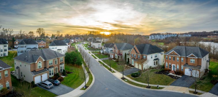 Aerial sunset view of luxury upscale residential neighborhood gated community street in Maryland USA