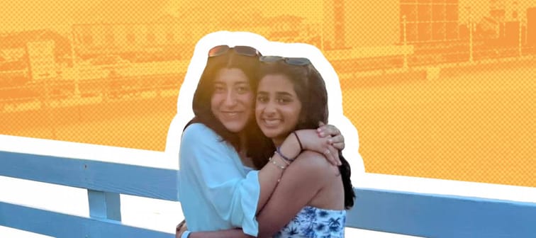 Anusha Ahmed and her friend standing on a dock during sunset