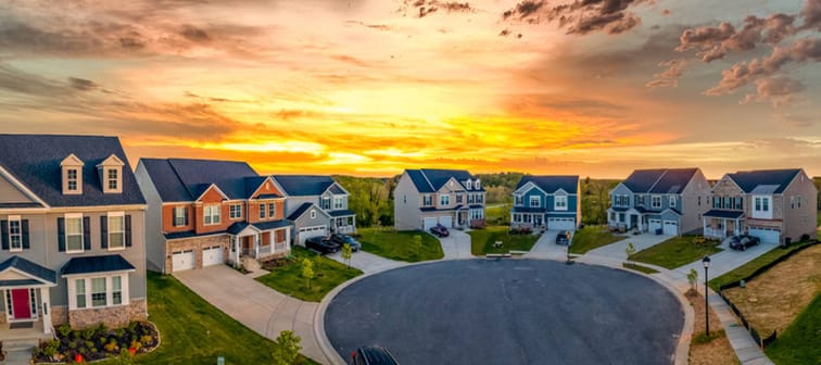 real estate development neighborhood with dramatic colorful sunset sky