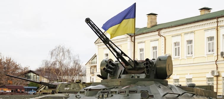 Army troops transporter and tank with Ukrainian flag, Ukraine - Russia war crisis concept, Kyiv