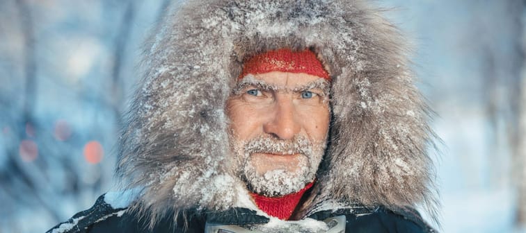 Older man covered in snow and ice