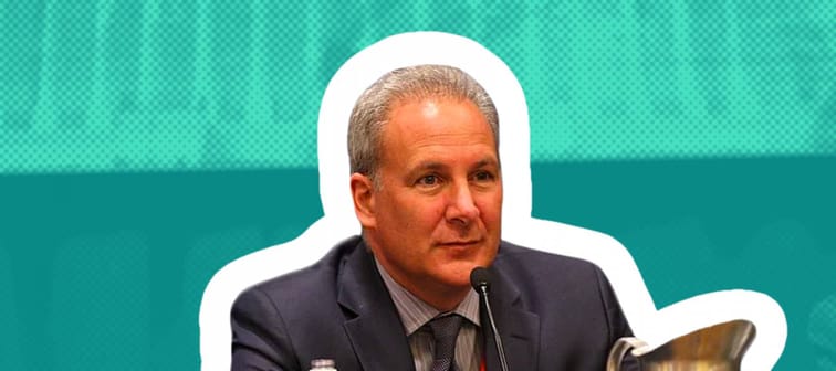 Peter Schiff sits in front of a microphone at a conference.