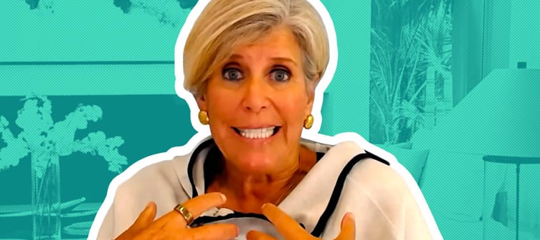 Suze Orman speaking and gesturing during a video interview.