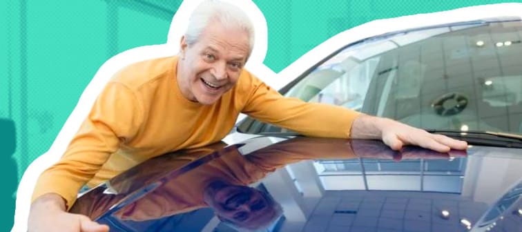 Excited man smiling joyfully hugging his newly bought automobile at car dealership