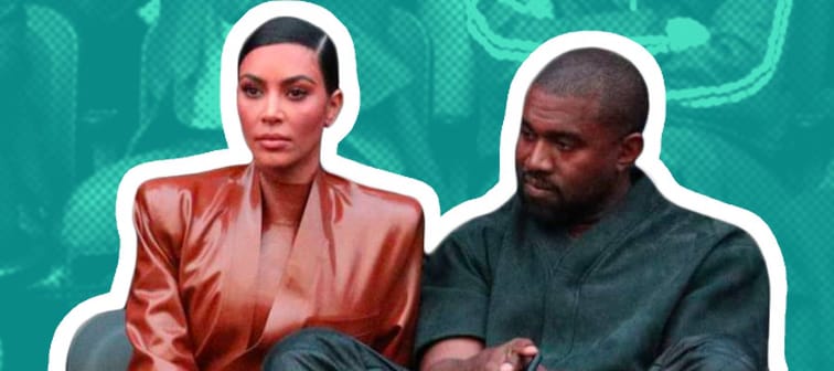 Kim Kardashian and Kanye West sit in the audience at a fashion show in Paris.