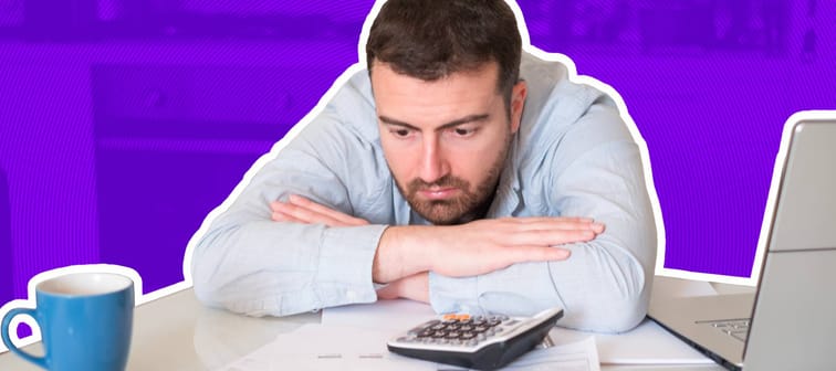 Man stressed with calculator
