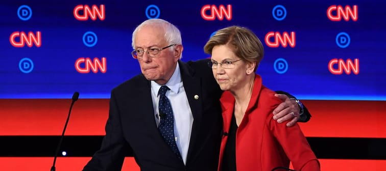 US senators Bernie Sanders (L) and Elizabeth Warren hug after participating in the first round of the second Democratic primary debate in 2019