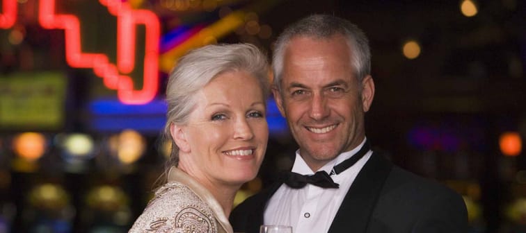 Mature couple celebrating with champagne in casino