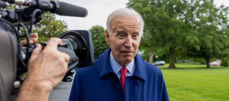 President Joe Biden speaks with reporters on the front lawn of the White House.