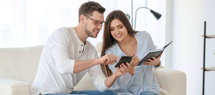 Young couple looks at their investments