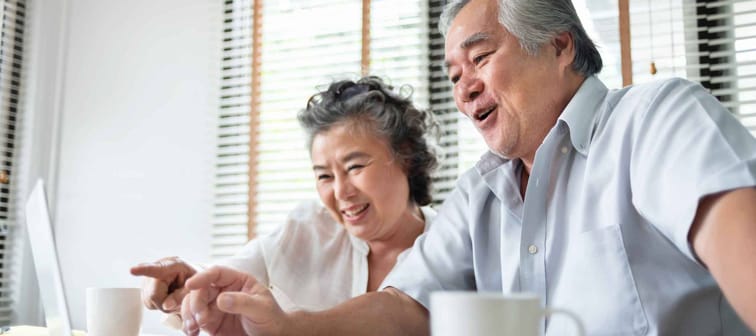 Relaxing Asian Senior couple making video call and talking with family