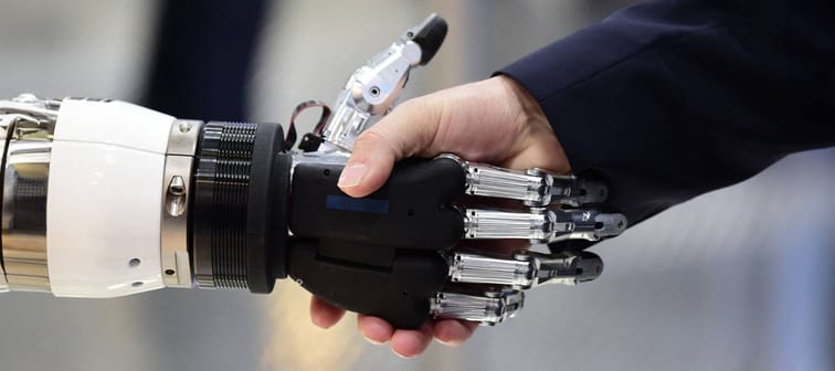 robot hand shaking human hand