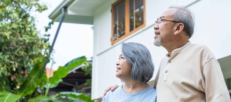 Asian Senior elderly couple standing outdoor at house feeling happy