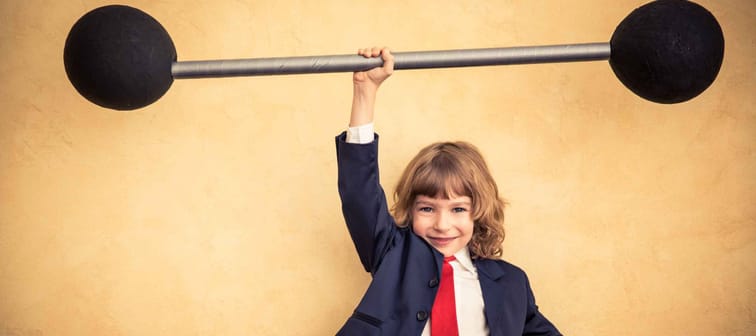 Strong businessman child holding barbell. Success and winner business concept