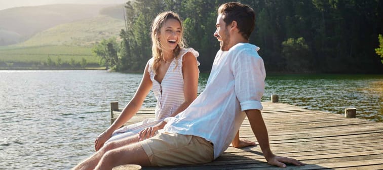 couple at lake for bonding,  sitting on dock by lake