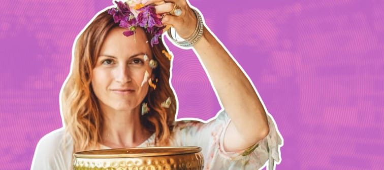 Woman holding herbs above a bowl